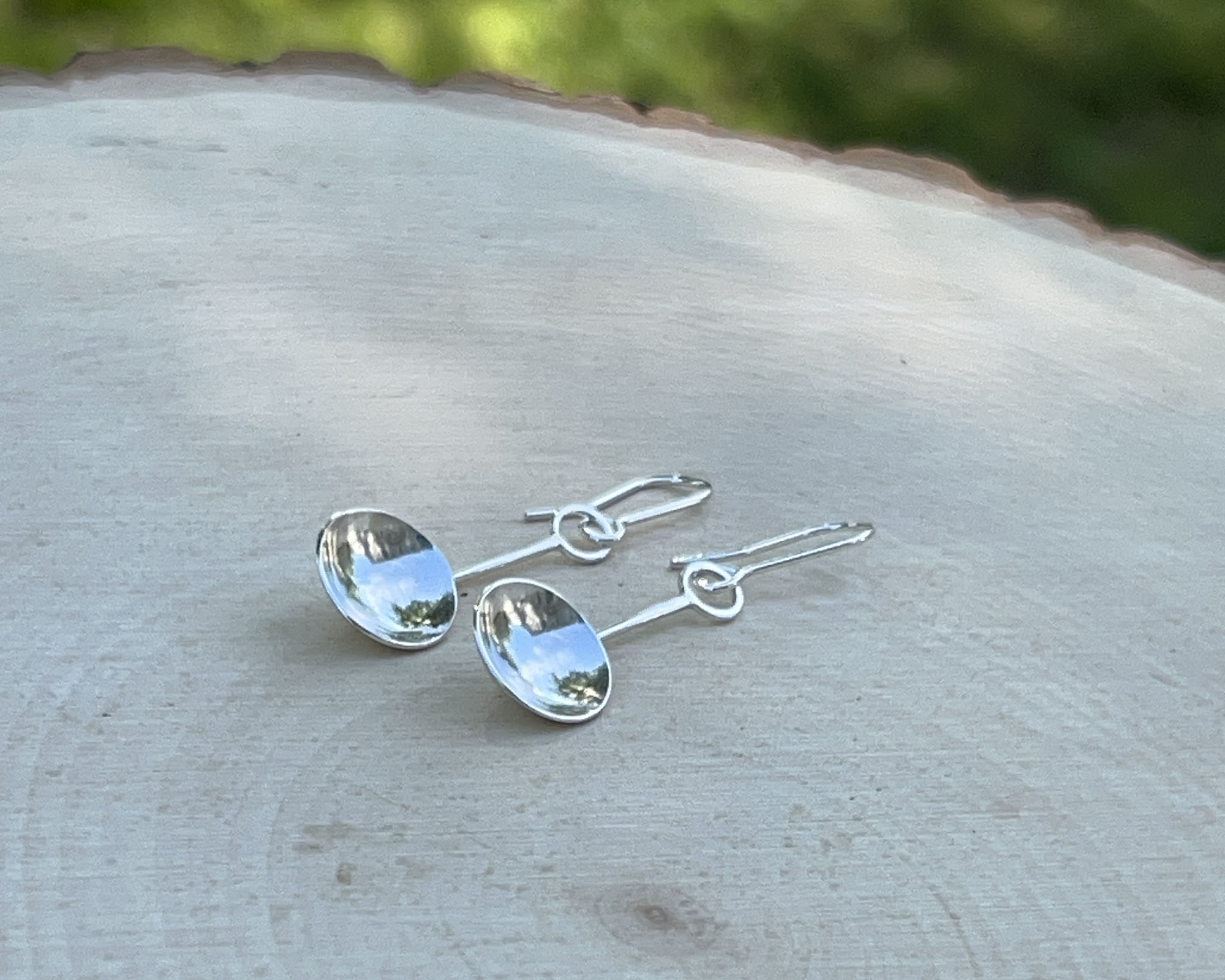 Domed sterling silver circles attached to sterling silver ear wires