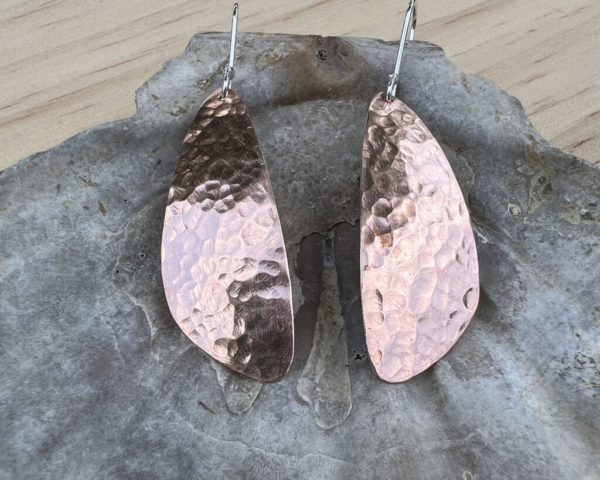 Teardrop shaped copper with a hammered finish with sterling silver ear wires attached