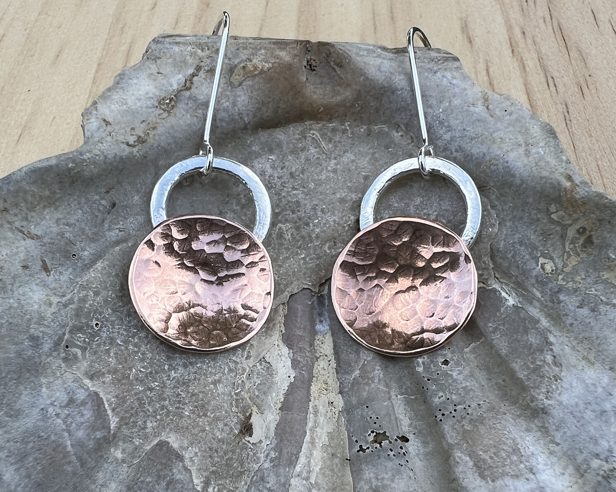 Copper circles with a hammered finish with sterling silver circles on top, attached sterling silver ear wires.