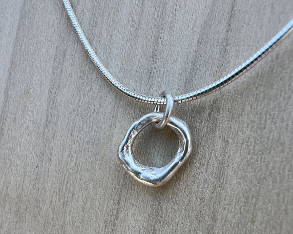 Tiny organic sterling silver circle on a sterling chain